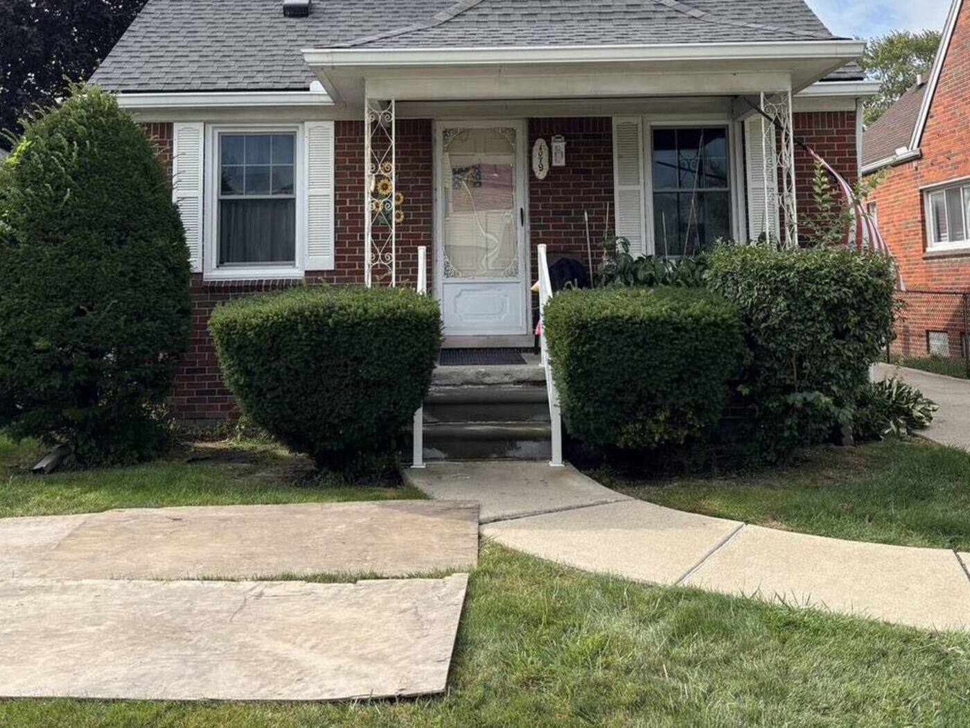 Before: overgrown shrubs across the front of the house