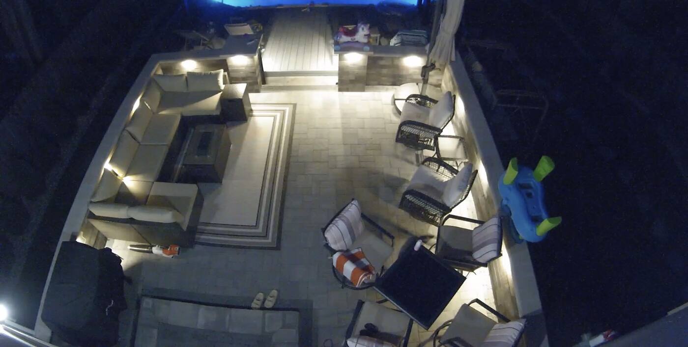 Same patio at night: Alliance lights under the double bullnose caps