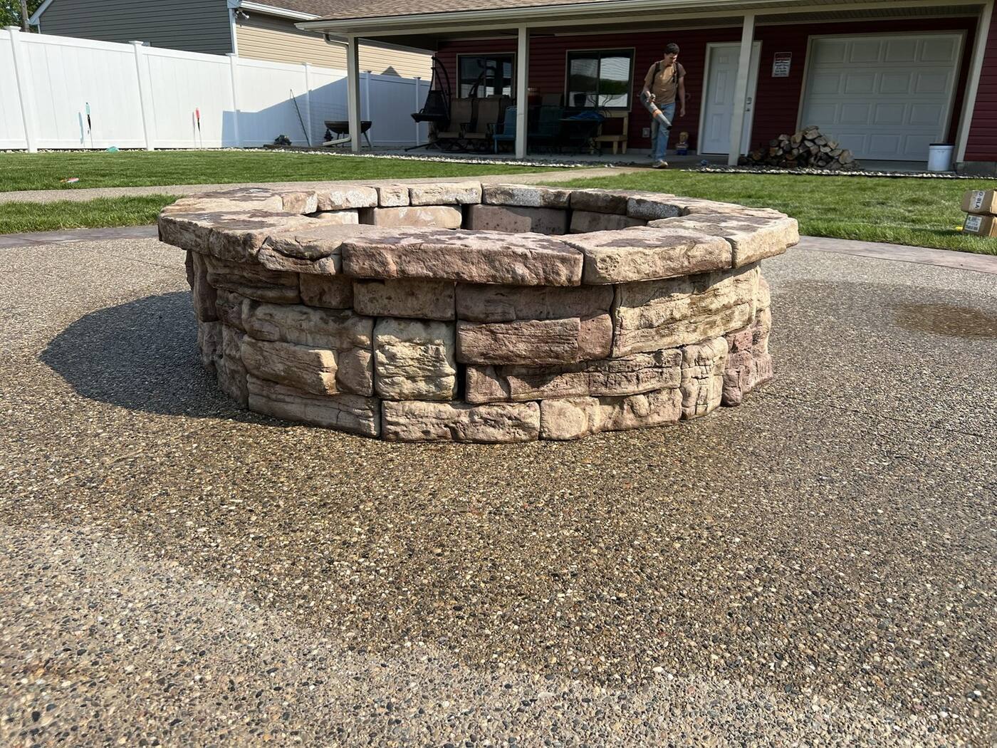 Stone fire pit on an exposed aggregate patio