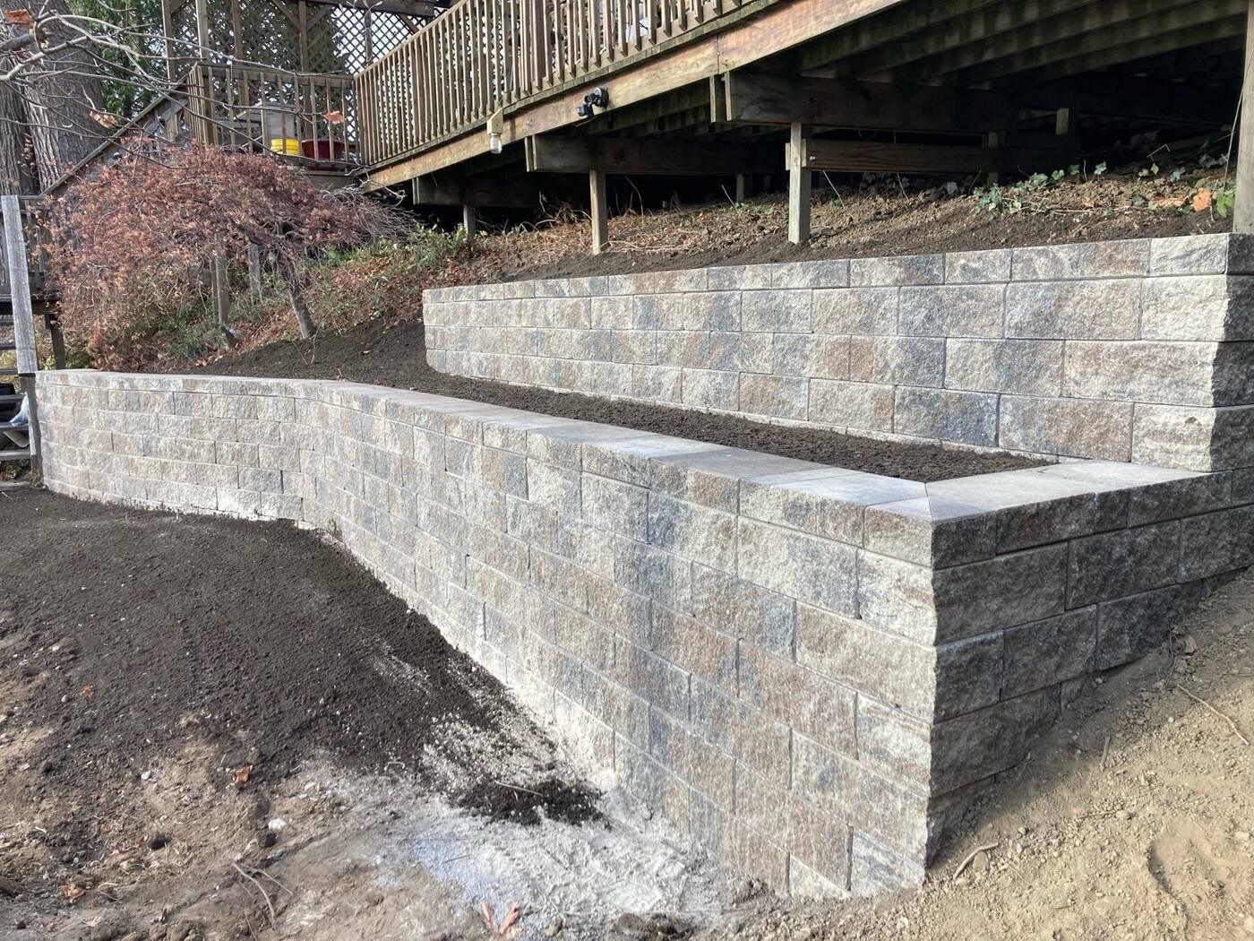 Tiered retaining walls under a deck